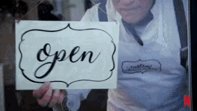 Business Closing Down Forever A shopkeeper turning "Open" sign on a glass door, to "Closed", with the camera panning down to display "Forever"